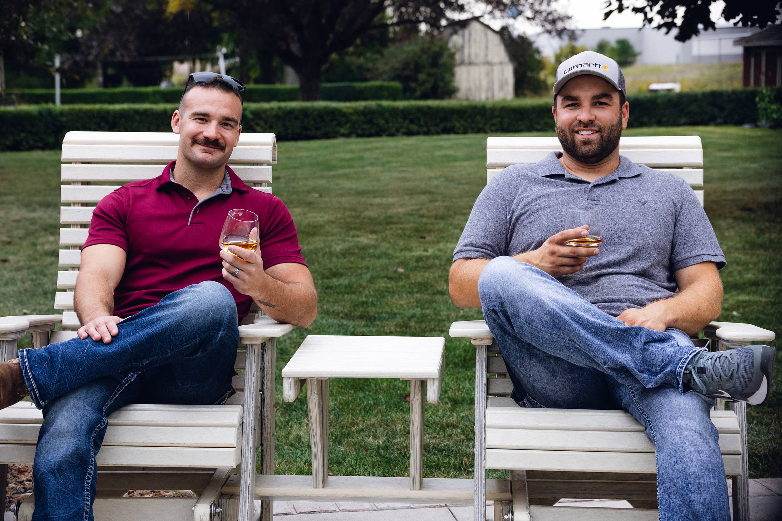 Two Individuals sitting on Evergreen Outdoor Furniture Rollback Chairs